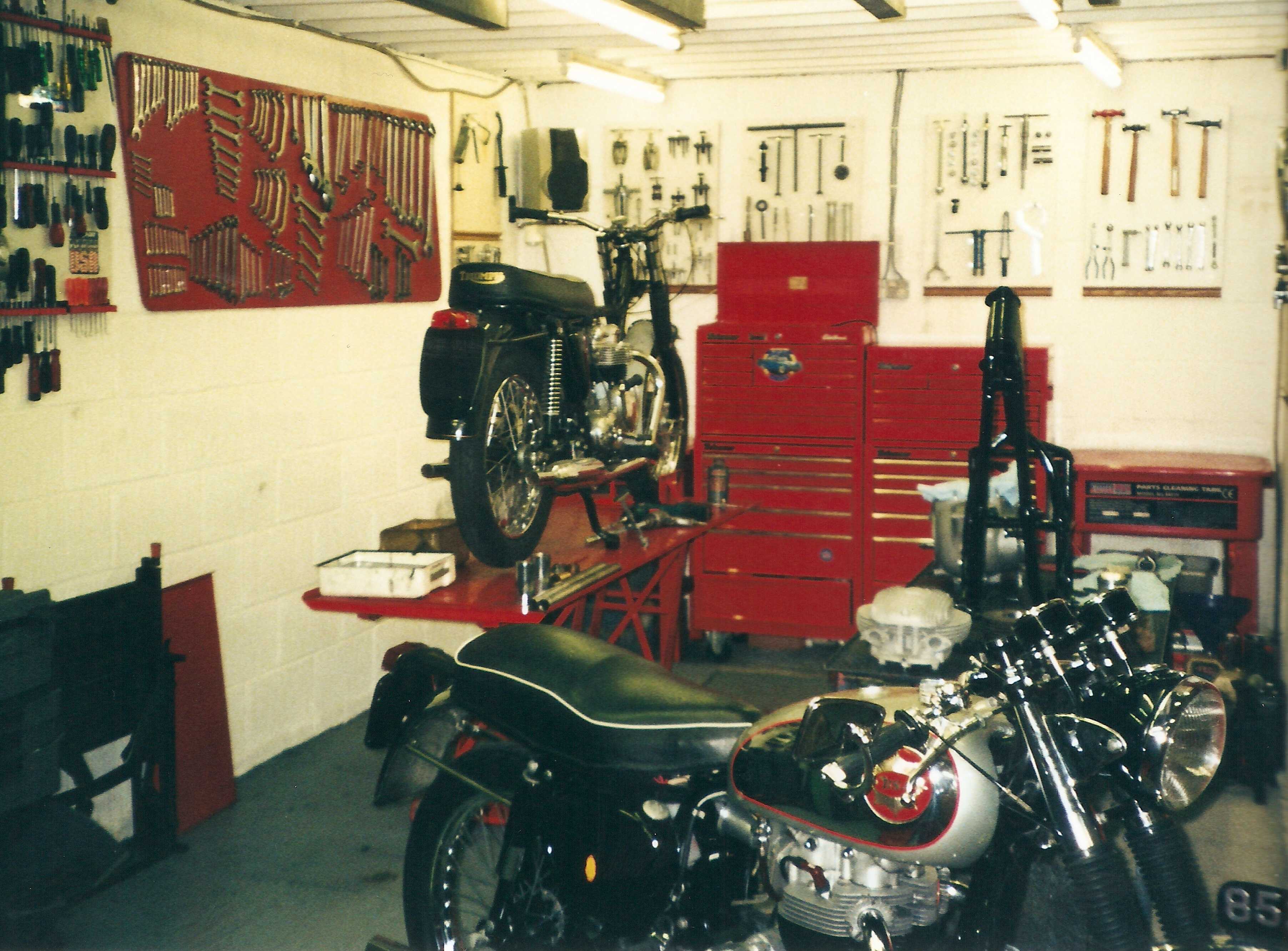 The tidy end of the workshop, the two longer stay ramps with an ex bath tub 5TA well into the restoration process, an A65 in the early stages and a Rocket Goldie on the floor awaiting a service